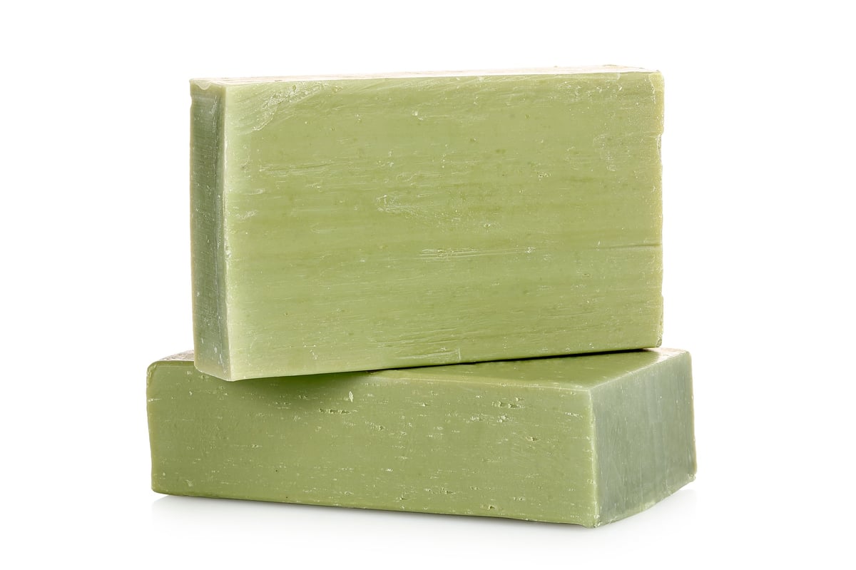 green soap bars made from olive oil isolated on white